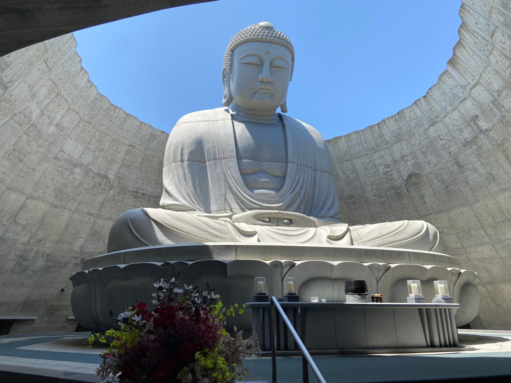 Inside the lavender-covered hill, a seated stone Buddha rests in quiet contemplation—Makomanai Takino’s hidden sanctuary.
