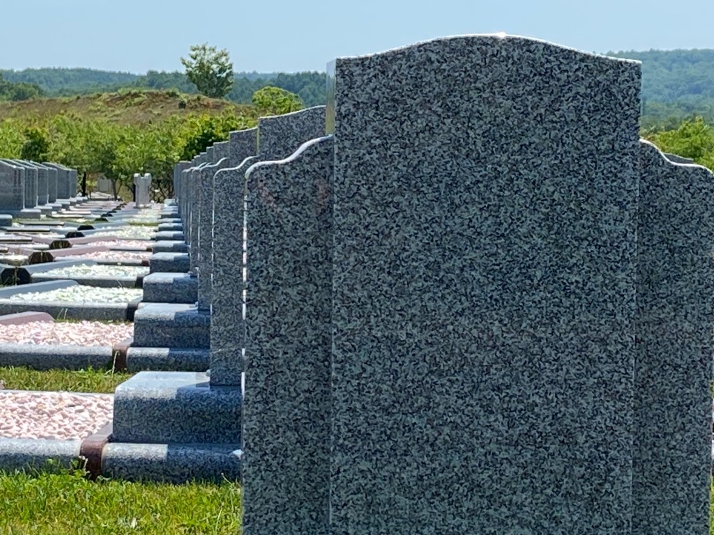 A weathered gravestone with no visible name—time and memory eroded in Makomanai Takino Cemetery.