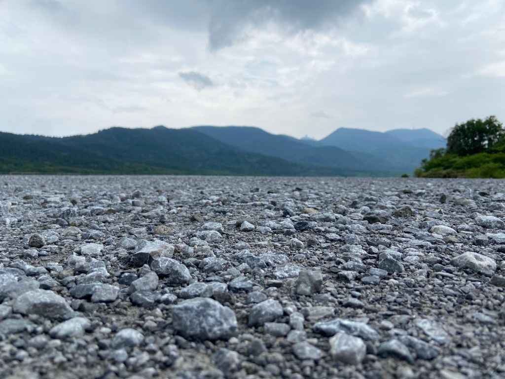 Desolate volcanic wasteland of Mount Osorezan in northern Japan, sacred Buddhist site known as the gateway to hell.